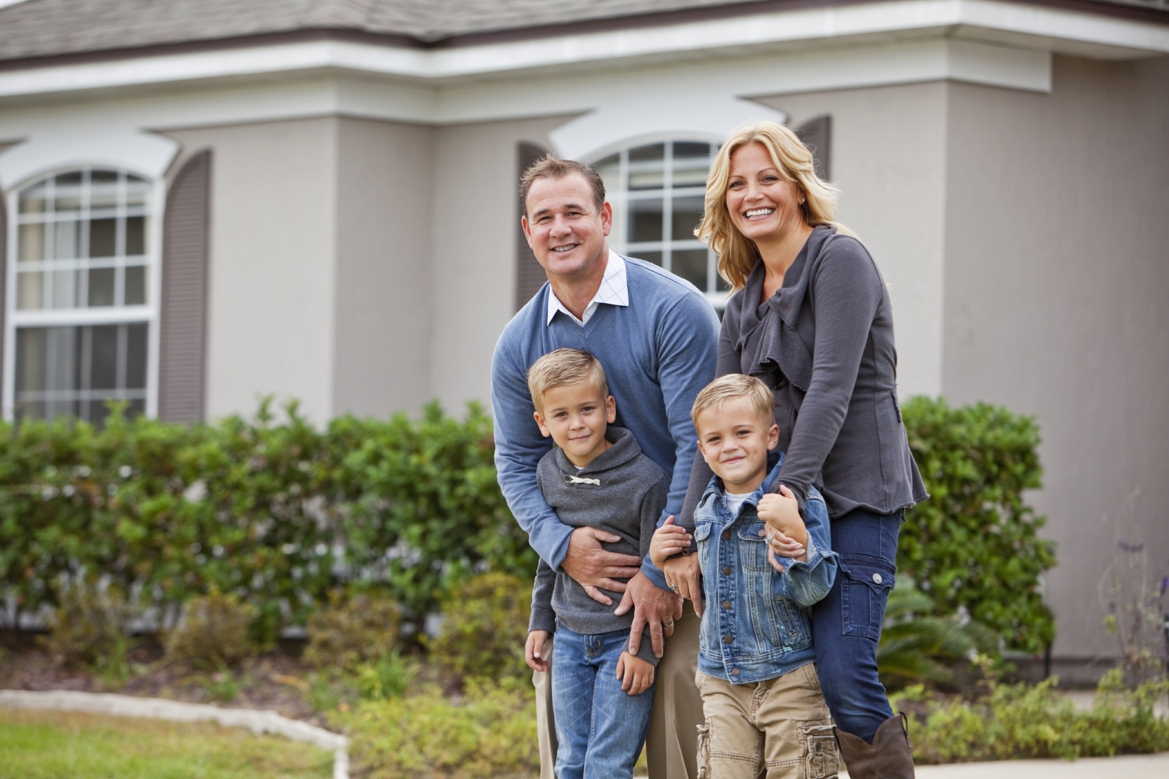 family in front of mobile home