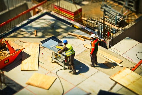 construction site, as seen from the perspective of a looming giant looking for his next meal