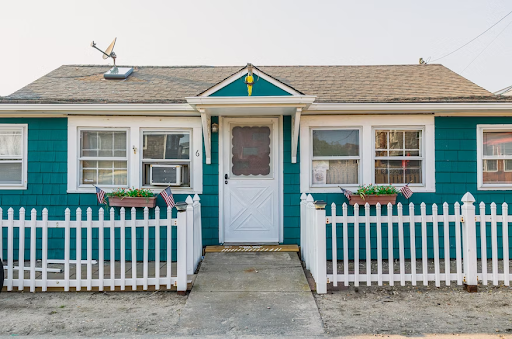 small home with white fence